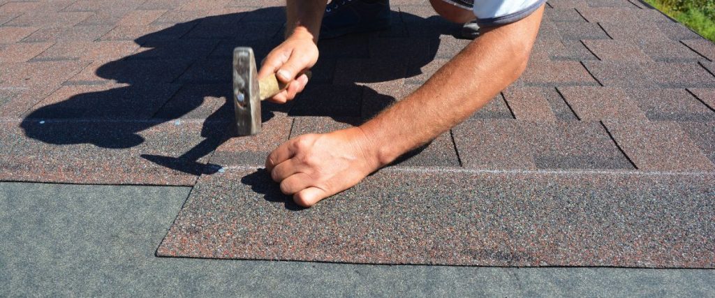 roof shingles being repaired